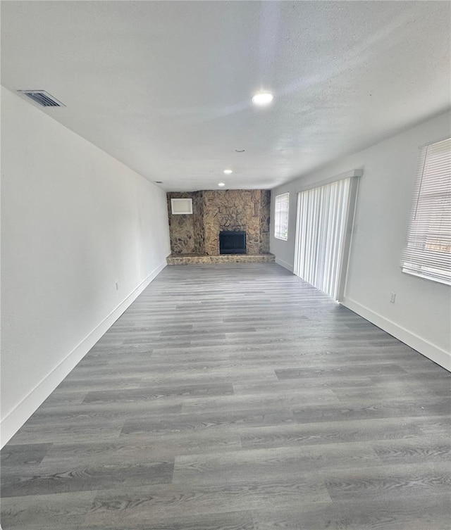4934 Avery Rd, New Port Richey, FL 34652 - unfurnished living room featuring a fireplace, wood finished floors, and recessed lighting