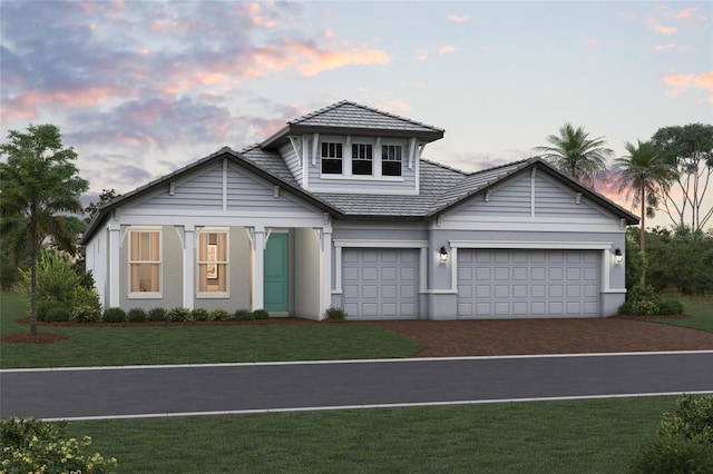 16811 Sweetwater Village Dr, Lakewood Ranch, FL 34211 - view of front of home featuring driveway, a garage, a front lawn, a tile roof, and stucco siding