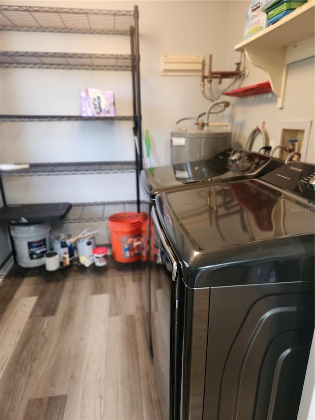 22481 Westchester Blvd Unit A19, Punta Gorda, FL 33980 - washroom featuring wood finished floors and washer and dryer