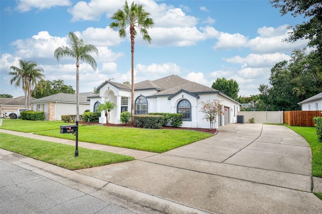 9844 Montclair Cir, Apopka, FL 32703 - view of front of house featuring concrete driveway, stucco siding, an attached garage, and a shingled roof