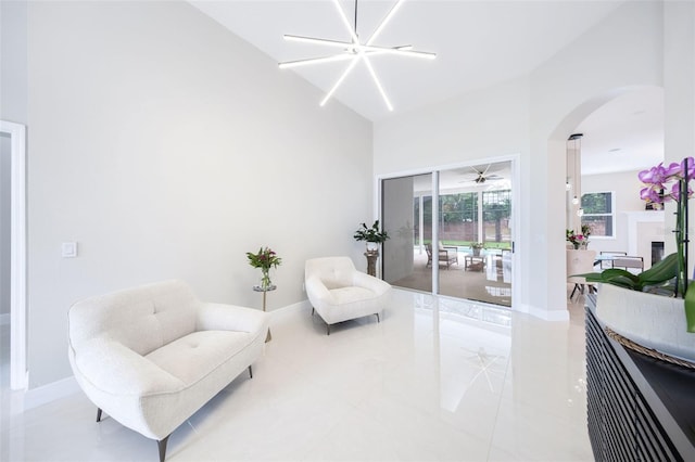 9844 Montclair Cir, Apopka, FL 32703 - sitting room with arched walkways, tile patterned floors, and a ceiling fan