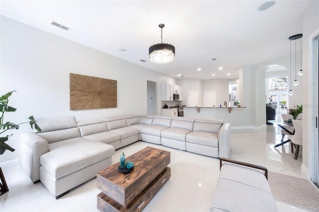 9844 Montclair Cir, Apopka, FL 32703 - living room with arched walkways, a chandelier, light tile patterned flooring, and recessed lighting