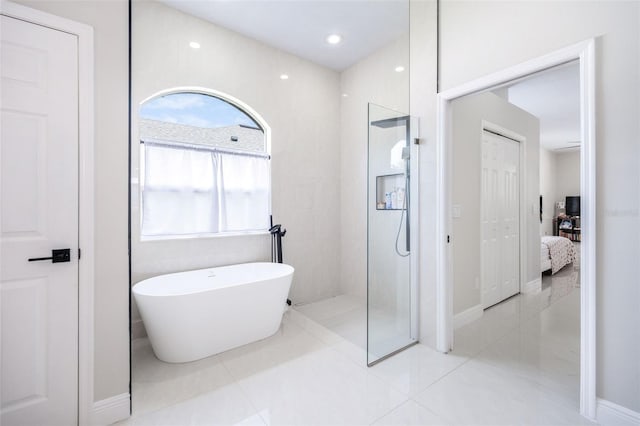 9844 Montclair Cir, Apopka, FL 32703 - ensuite bathroom with a walk in shower, a freestanding tub, plenty of natural light, and tile patterned floors