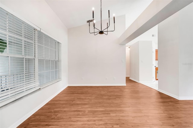 11442 Beggs Ct, Clermont, FL 34711 - unfurnished dining area with a chandelier, a towering ceiling, and light wood-style flooring