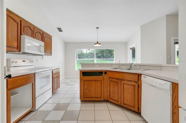 11442 Beggs Ct, Clermont, FL 34711 - kitchen with white appliances, light countertops, and brown cabinetry