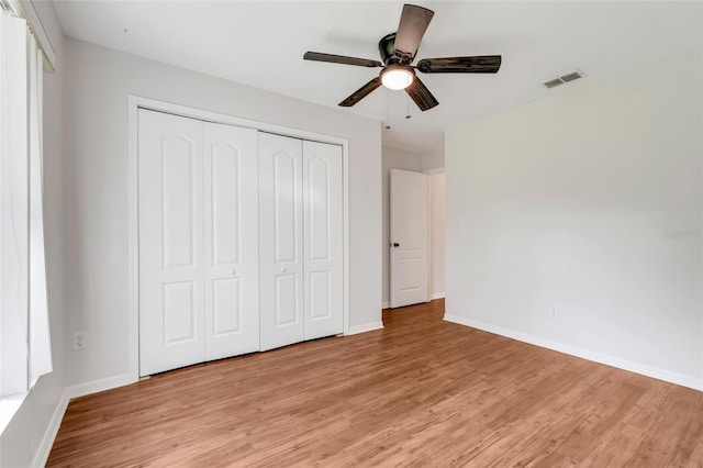 11442 Beggs Ct, Clermont, FL 34711 - unfurnished bedroom with light wood finished floors, a closet, and a ceiling fan