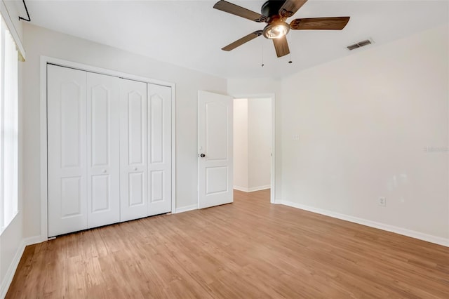 11442 Beggs Ct, Clermont, FL 34711 - unfurnished bedroom with light wood finished floors, a closet, and ceiling fan