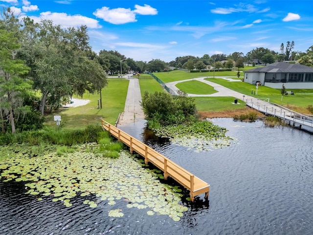 11442 Beggs Ct, Clermont, FL 34711 - surrounding community with a lawn and a water view