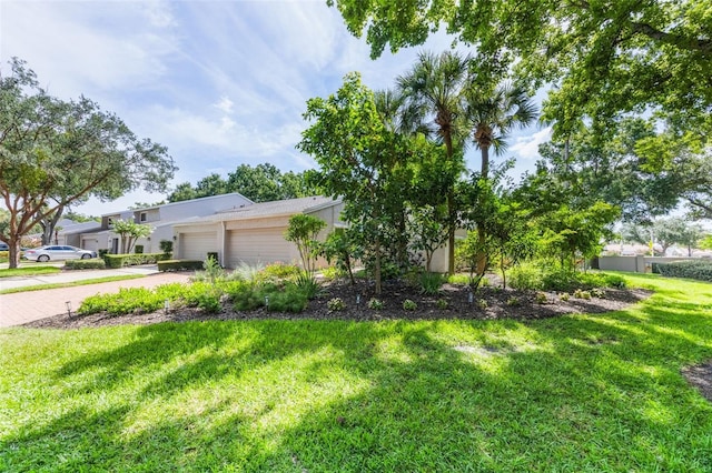 7755 High Pine Rd, Orlando, FL 32819 - view of front of home featuring a garage, driveway, a front yard, and stucco siding