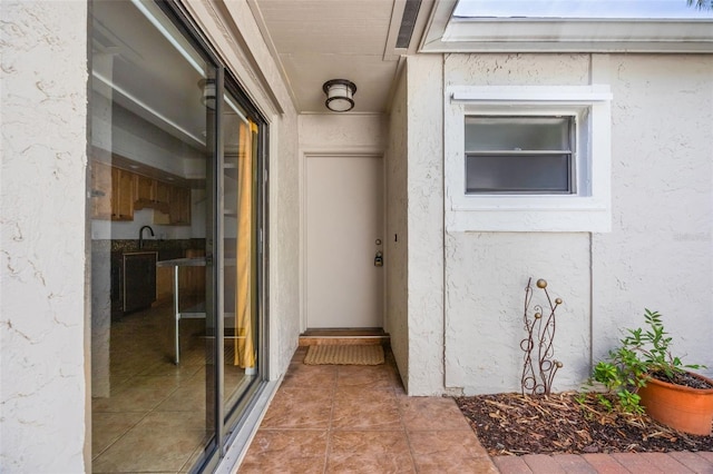 7755 High Pine Rd, Orlando, FL 32819 - view of exterior entry featuring stucco siding