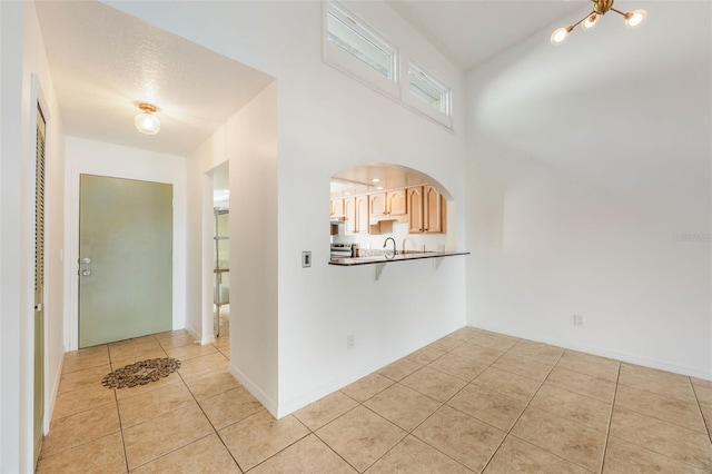 7755 High Pine Rd, Orlando, FL 32819 - foyer with light tile patterned floors and a chandelier