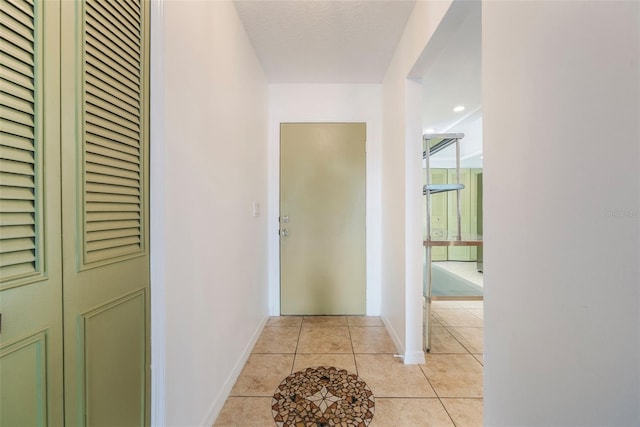 7755 High Pine Rd, Orlando, FL 32819 - hallway with light tile patterned floors and baseboards