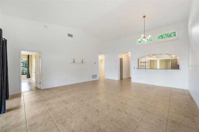 7755 High Pine Rd, Orlando, FL 32819 - unfurnished living room with high vaulted ceiling, light tile patterned flooring, and a chandelier