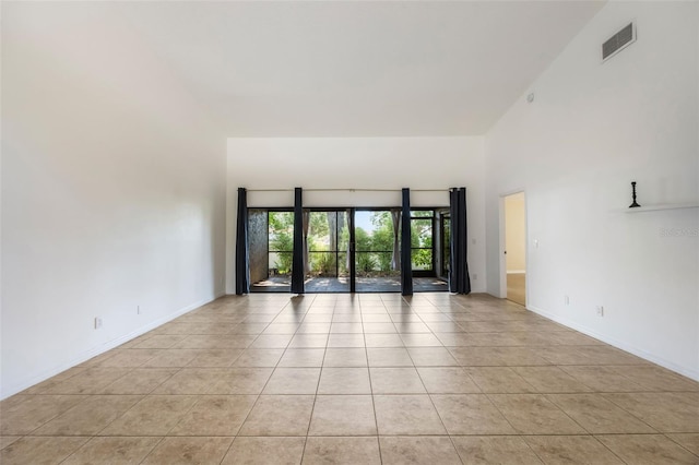 7755 High Pine Rd, Orlando, FL 32819 - unfurnished room featuring light tile patterned flooring and a towering ceiling