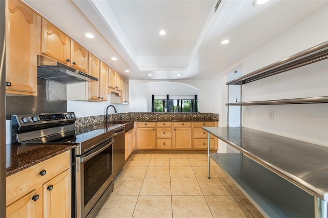 7755 High Pine Rd, Orlando, FL 32819 - kitchen with stainless steel appliances, under cabinet range hood, light brown cabinetry, recessed lighting, and dark stone countertops