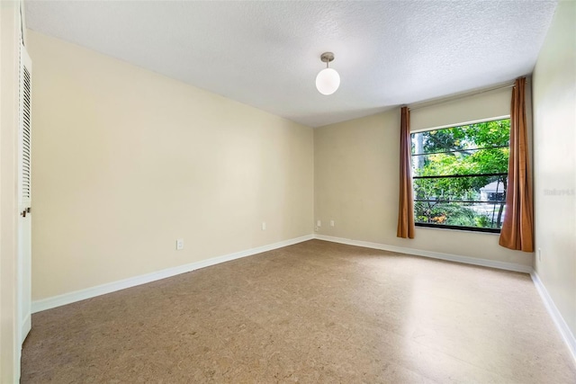 7755 High Pine Rd, Orlando, FL 32819 - spare room with a textured ceiling and baseboards
