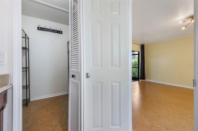 7755 High Pine Rd, Orlando, FL 32819 - hall with a textured ceiling and tile patterned floors