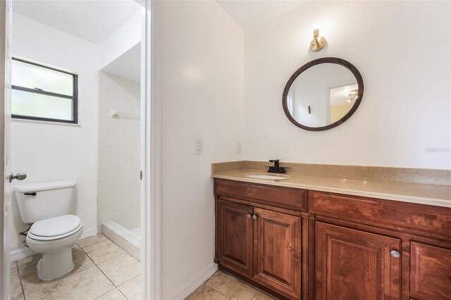 7755 High Pine Rd, Orlando, FL 32819 - bathroom with vanity, tiled shower, and tile patterned floors