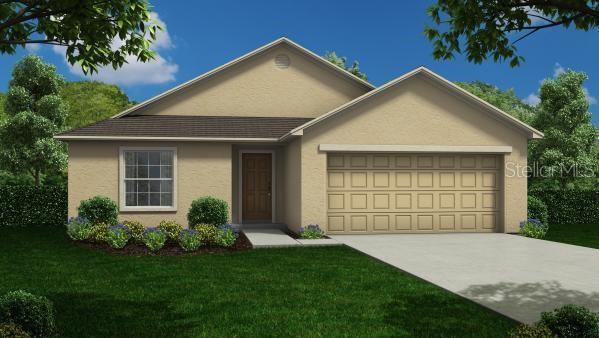 616 Broadway St W, Fort Meade, FL 33841 - view of front facade featuring a garage, stucco siding, concrete driveway, and a front yard