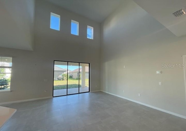 1940 Goblet Cove St, Kissimmee, FL 34746 - unfurnished room featuring baseboards and a towering ceiling