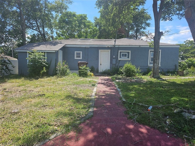115 N 10th St, Haines City, FL 33844 - single story home with stucco siding and a front yard