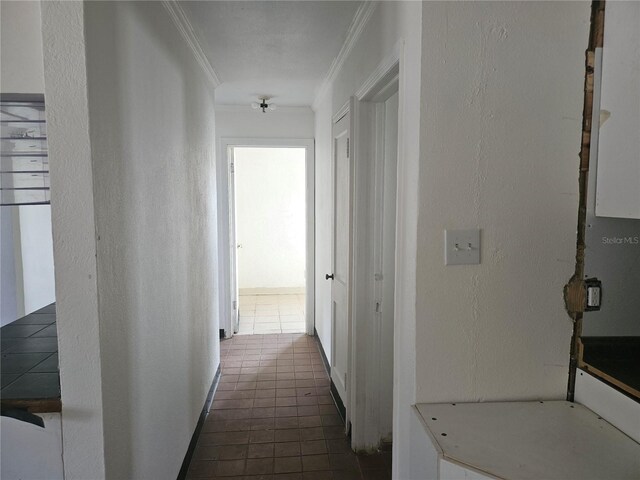 115 N 10th St, Haines City, FL 33844 - hall with crown molding, a textured wall, and dark tile patterned floors
