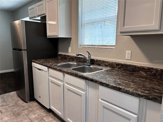 3304 Dew Berry Ave, Apopka, FL 32712 - kitchen with dishwasher, white cabinetry, light tile patterned floors, dark stone countertops, and a textured wall