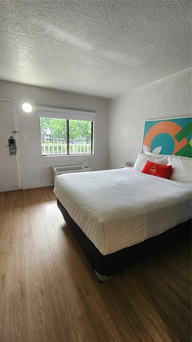 5367 W Irlo Bronson Memorial Hwy Unit 2-206, Kissimmee, FL 34746 - bedroom featuring wood finished floors and a textured ceiling