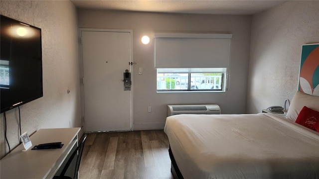 5367 W Irlo Bronson Memorial Hwy Unit 3-216, Kissimmee, FL 34746 - bedroom with wood finished floors, a textured wall, and a wall unit AC