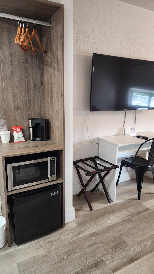 5367 W Irlo Bronson Memorial Hwy Unit 3-216, Kissimmee, FL 34746 - home office with light wood-style floors and a textured wall