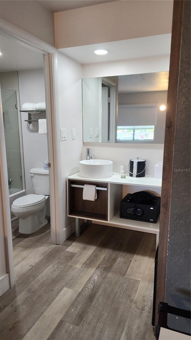 5367 W Irlo Bronson Memorial Hwy Unit 3-216, Kissimmee, FL 34746 - bathroom featuring wood finished floors, vanity, shower / bath combination with glass door, and recessed lighting