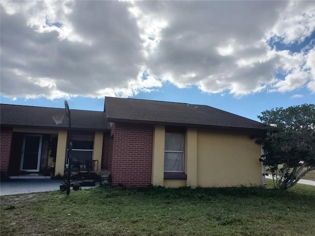 back of house with a lawn