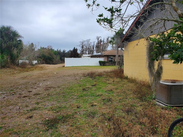 view of yard featuring central air condition unit