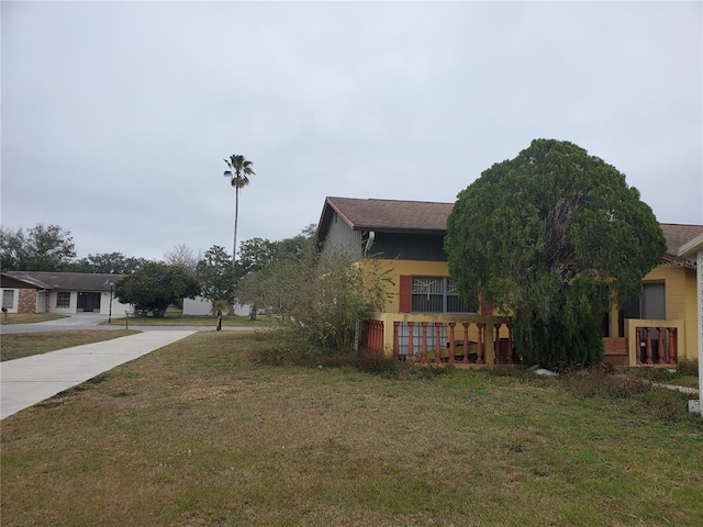 view of property exterior with a lawn