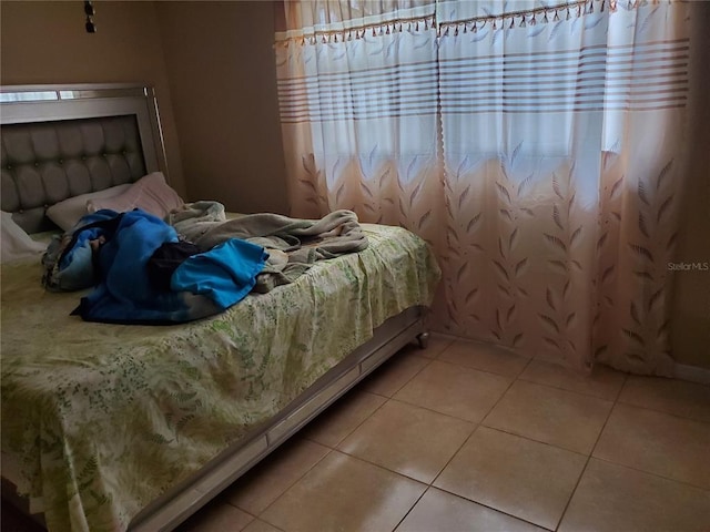 bedroom with light tile floors