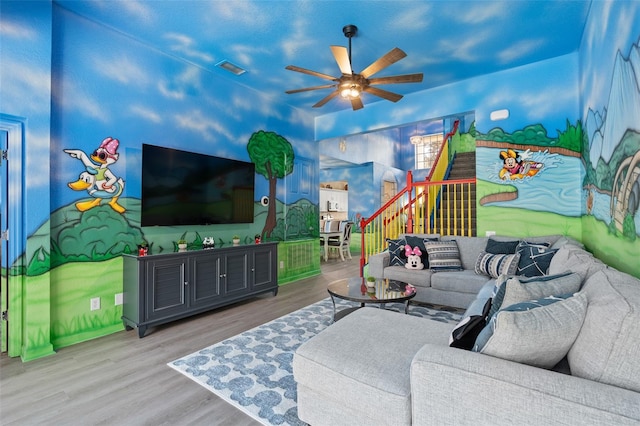 living room with ceiling fan and light hardwood / wood-style flooring