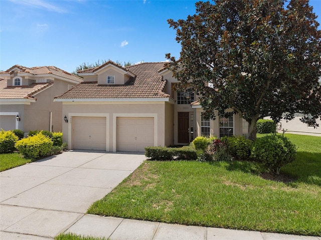 mediterranean / spanish house featuring a front yard and a garage