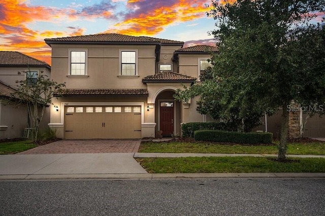 mediterranean / spanish-style home featuring a garage