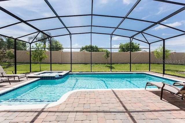 view of swimming pool with glass enclosure, a patio, and an in ground hot tub