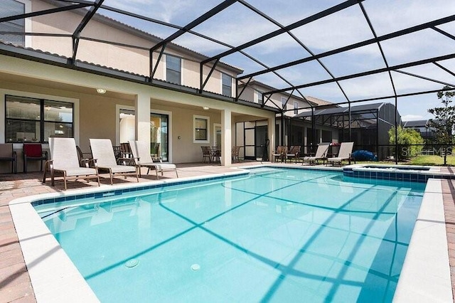 view of swimming pool featuring a lanai and a patio area