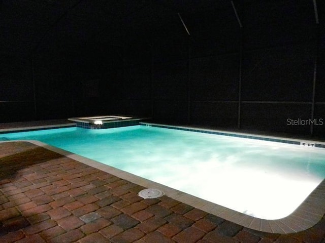 view of pool featuring an in ground hot tub