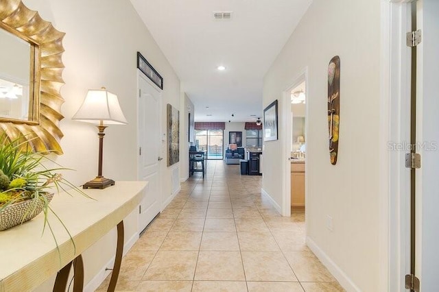 hall featuring light tile patterned floors