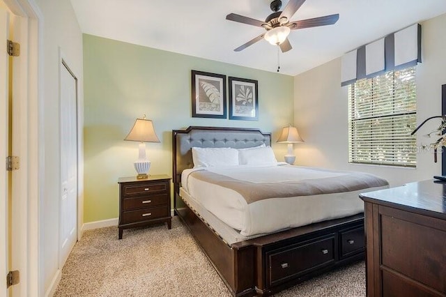 bedroom featuring light carpet and ceiling fan