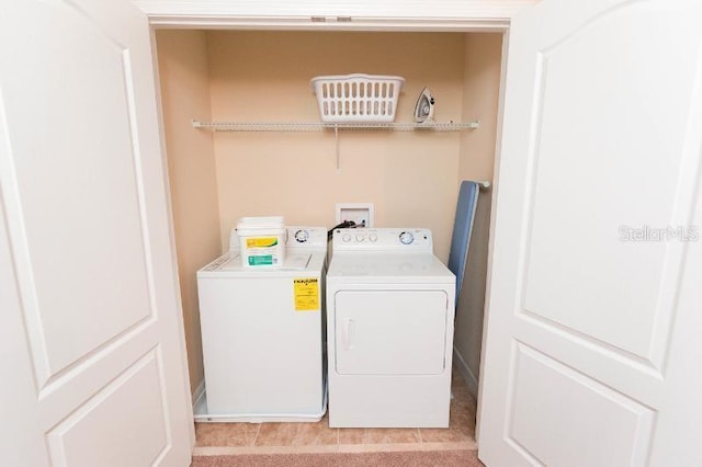 clothes washing area with washing machine and clothes dryer