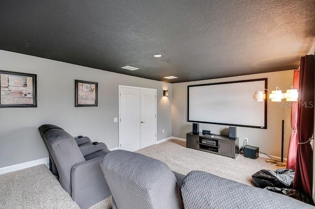 carpeted home theater room featuring a textured ceiling