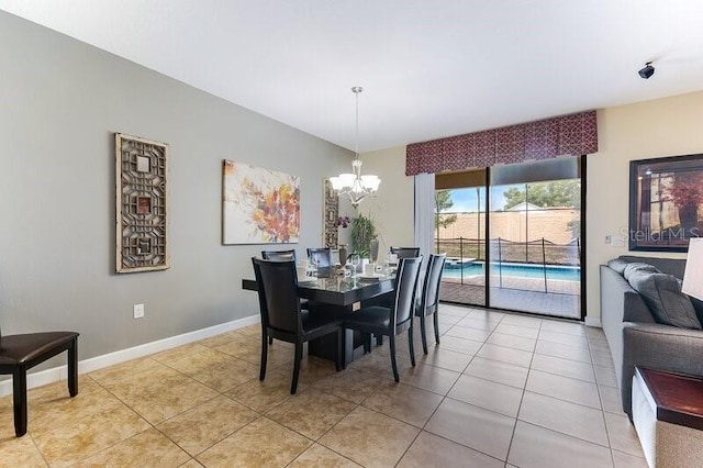 tiled dining area featuring an inviting chandelier