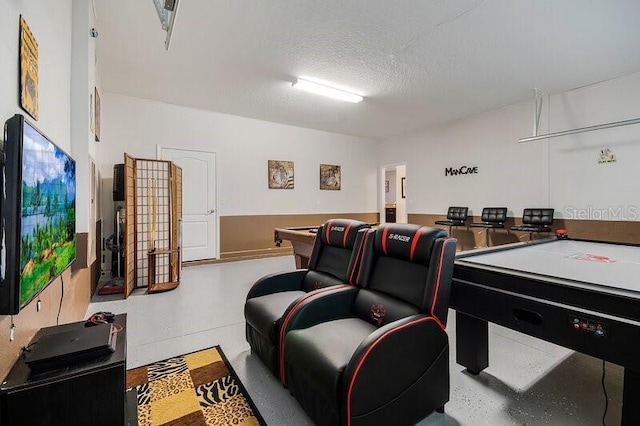 recreation room featuring billiards and a textured ceiling