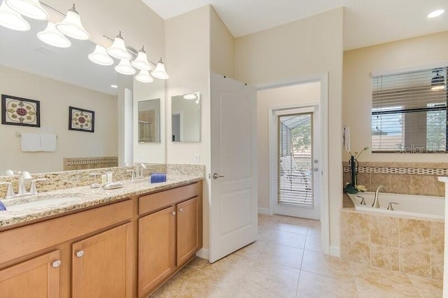 bathroom with vanity, tile patterned floors, and tiled tub