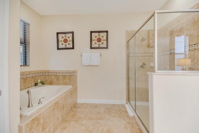 bathroom featuring tile patterned flooring and shower with separate bathtub