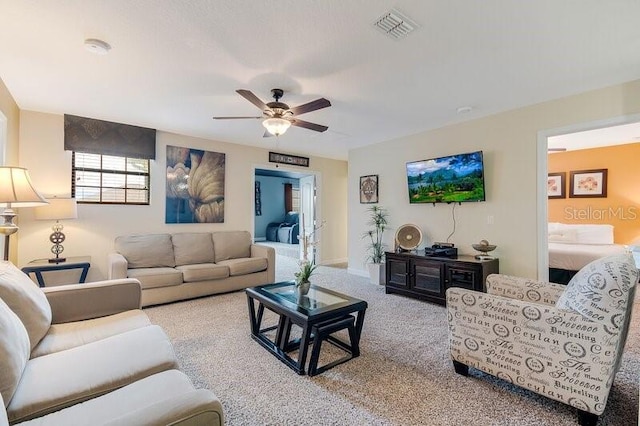 carpeted living room featuring ceiling fan